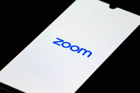 Vilnius, Lithuania - December 17 2020: Zoom Video Communications app on the smartphone with finger, video conferences and online chat services for meetingのeditorial素材
