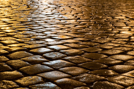 Wet cobblestones at night after rain on a street or road surface, bottom viewの写真素材