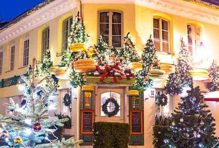 Vilnius, Lithuania - December 18 2020: Beautiful Christmas decorations in Vilnius, Lithuania, with Christmas trees and giant macaroons, lights and night backgroundのeditorial素材