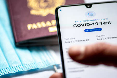 Rome, Italy, - January 17 2021: Vaccine passport app displayed an a smartphone with passport and...