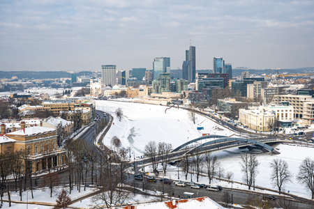 Vilnius, capital of Lithuania, beautiful scenic aerial panorama of modern business financial district architecture buildings with snow, Neris river and bridgeの写真素材