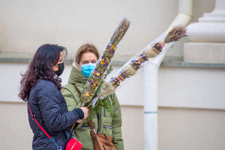 Vilnius, Lithuania - March 28 2021: Palm and Easter day, women wearing mask in the flowers market