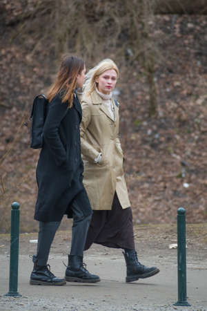 Vilnius, Lithuania - March 28 2021: Beautiful couple of young girls without mask, walking in the...