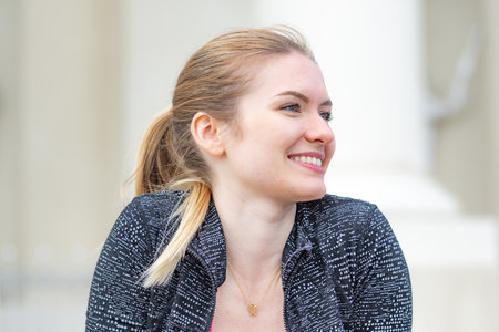Vilnius, Lithuania - April 2021: Portrait of beautiful lovely young blonde hair girl smiling and enjoying good weather and life in the cityのeditorial素材