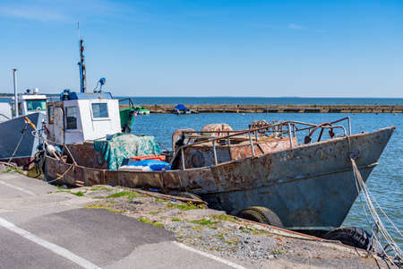 Old, rusty fishermen boat abandoned in the harbor