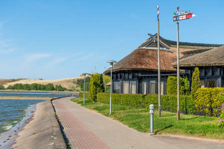 Nida, Lithuania - May 23 2021: Beautiful old Lithuanian traditional wooden houses with thatched...