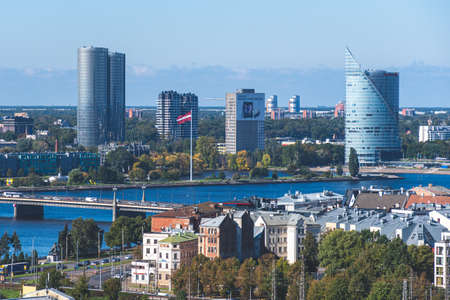 Riga, Latvia - September 19 2021:  Riga panorama with Daugava river, bridge, flag of Latvia and...