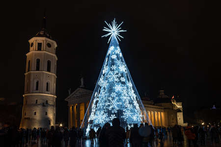 Vilnius, Lithuania - November 28 2021: Beautiful white Christmas tree with snowflakes in Vilnius Cathedral square, Lithuania, Europe, no market and events due to Covid or Coronavirus pandemicのeditorial素材