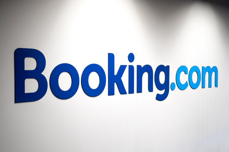 Vilnius, Lithuania - February 13 2022: Booking.com logo on a white wall of an office lighted by...