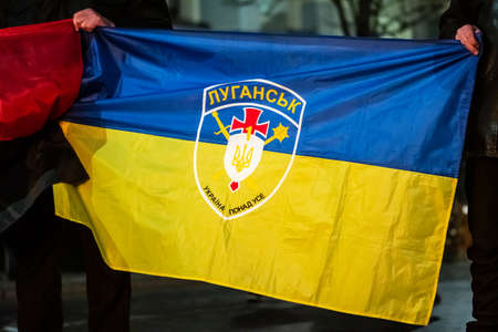 Luhansk, Lugansk, Ukraine - February 16 2022: Flag of Ukraine with symbol or logo of Luhansk or...