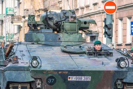 Vilnius, Lithuania - February 16 2022: Armored crawler tank with cannon and female soldier driving in the city. German Army, member of NATO or North Atlantic Treaty Organizationのeditorial素材