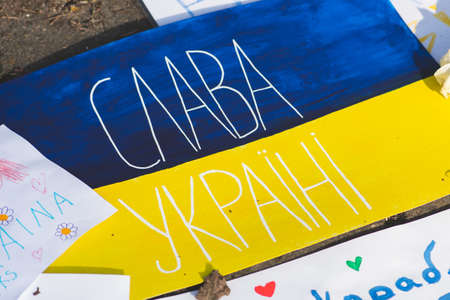 Vilnius, Lithuania - March 2, 2022: Placards during a peaceful demonstration against war, Putin and Russia in support of Ukraine, with Ukrainian flags. Stop Warのeditorial素材