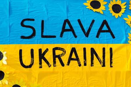 Beautiful painted Ukrainian flag and ribbon during a peaceful demonstration against war, Putin and...