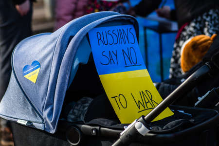 Stroller with placard during a peaceful demonstration against war, Putin and Russia in support of...