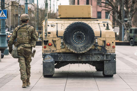 United States- March 29 2022: United States Marine Corps soldiers with shotgun, rifle, helmets and military vehicles and humvee, USA or US army troops ready for drills, battle or war in the cityのeditorial素材