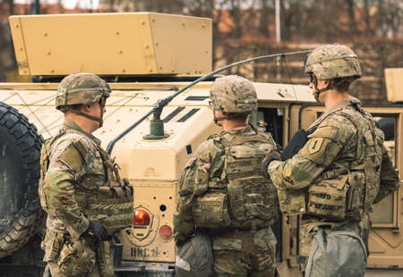 United States- March 29 2022: United States Marine Corps soldiers with shotgun, rifle, helmets and military vehicles and humvee, USA or US army troops ready for drills, battle or war in the cityのeditorial素材