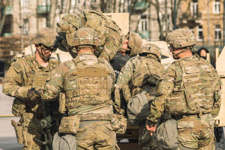 United States- March 29 2022: United States Marine Corps soldiers with shotgun, rifle, helmets and military vehicles and humvee, USA or US army troops ready for drills, battle or war in the cityのeditorial素材