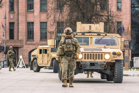 United States - March 29 2022: United States Marine Corps soldiers with weapons, helmets and armored vehicles humvee, USA or US army troops ready for drills or war in the cityのeditorial素材