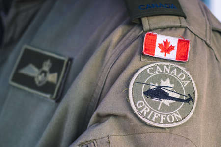 Toronto, Canada - March 29 2022: Flag of Canada and Griffon, Royal Canadian Air Force on a pilot soldier uniform, force integration unit, close upのeditorial素材