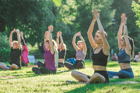 Vilnius, Lithuania - June 22 2022: Beautiful girls making outdoor or outside activity, yoga or gym...