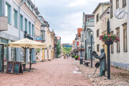 Parnu, Estonia, Europe - June 19 2022: Parnu old town street with life-size sculpture of Johann Voldemar Jannsen, the father of Estonian journalism and author of national anthemのeditorial素材