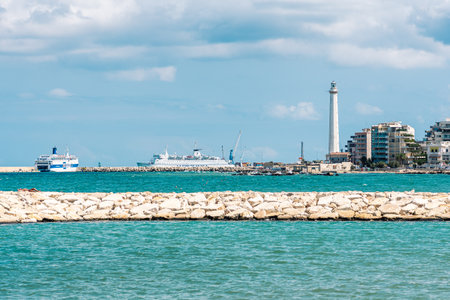 Bari, Puglia, Italy - August 29 2021: Bari port or harbor with breakwater, cruise ships and lighthouse on backgroundのeditorial素材