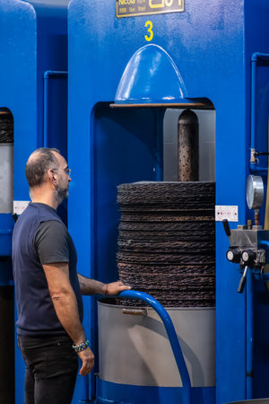 Bari, Puglia, Italy - November 8 2022: Ecological extra virgin olive oil production with modern technology, tanks, cans, press machine and workers, men at workのeditorial素材