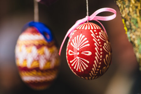 Traditional Lithuanian wooden colorful Easter egg, symbol of fertility and life painted with the symbols of nature, close upの写真素材