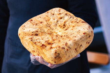 Selling homemade bio natural seasoned cheese with spices in a street food market, close upの写真素材