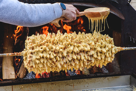 Preparing Lithuanian tree cake, Å¡akotis or baumkuchenas, Polish sÄkacz, Belarusian bankucha, German baumkuchen made of butter, egg whites and yolks, flour, sugar, and cream, cookedの写真素材