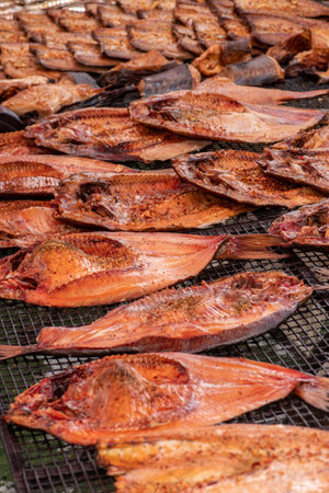 Selling various smoked fish in a street food market in Vilnius, Lithuania, Europe, close up, verticalの写真素材