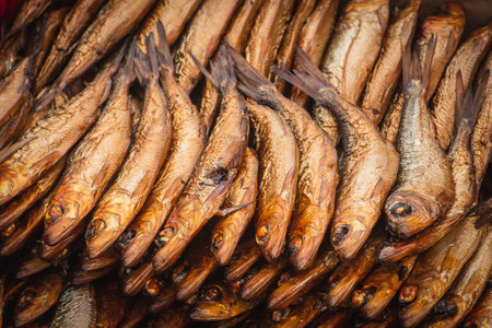 Dried smoked Atlantic or Baltic herrings, Clupea harengus, a herring in the family Clupeidae in a street food market in Vilnius, Lithuania, Europe, close upの写真素材