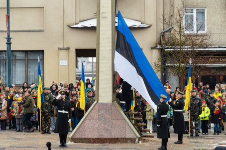 Tallinn, Estonia - March 11 2023: Flags of Estonia and Ukraine flags waving together during a flag raising in an official ceremony with soldiersのeditorial素材