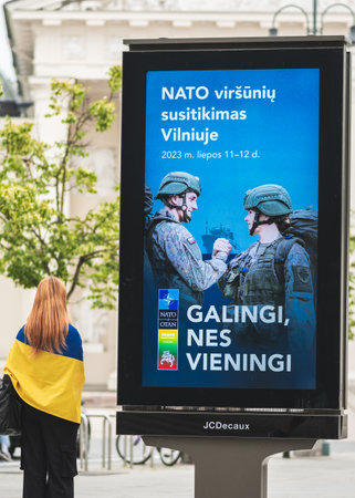 Vilnius, Lithuania - June 22 2023: Advertising banner informing about the upcoming Nato summit 2023 in the center of Vilnius, capital of Lithuania with girl with flag of Ukraineのeditorial素材