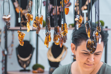 Amber necklaces. Amber of different colors and sizes. Exposition of stones of amber for tourists in a street marketのeditorial素材
