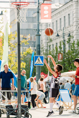 Child playing basketball during a sporting event in Vilnius, Lithuania, Europe, verticalのeditorial素材