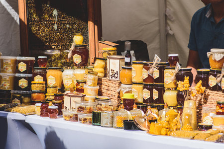 Selling organic natural bio honey, pollen, beeswax candles and other bee products in a street food...