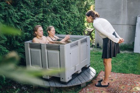 Beautiful couple ice bathing in the cold water among ice cubes with instructor. Wim Hof Method, cold therapy, breathing techniques, yoga and meditationのeditorial素材