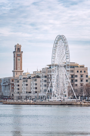 Bari, Puglia, Italy - December 30 2023: Panorama of Bari, Puglia or Apulia, southern Italy with Mediterranean Sea, street lamps, ferris wheel and fascist architectureのeditorial素材