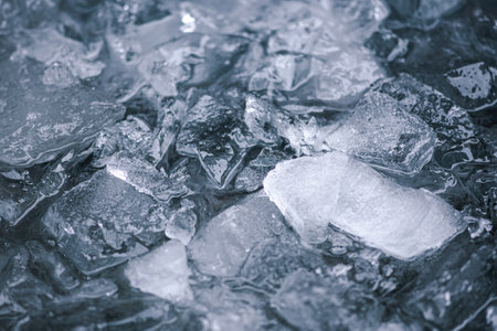 Cold water and ice cubes melting background. Global warming or climate change concept. Cold therapy, breathing techniques, Wim Hof Method, yoga and meditationの写真素材
