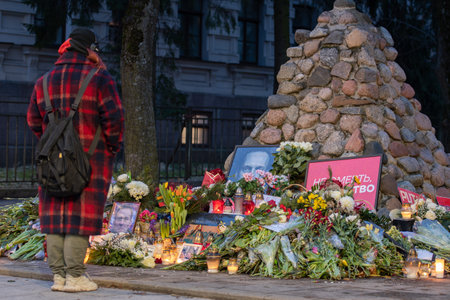 Vilnius, Lithuania - February 21 2024: Flowers and candles laid at spontaneous memorial in Vilnius...