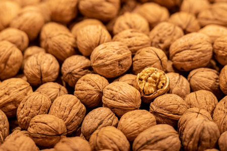 Walnuts in a fruit and vegetable street market, a walnut is open and the kernel is visible