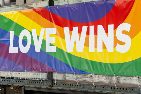 Truck with rainbow coloured banner and with the writing Celebrate Pride