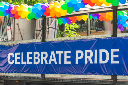 Truck with rainbow colored balloons and with the writing on the banner Celebrate Prideの写真素材