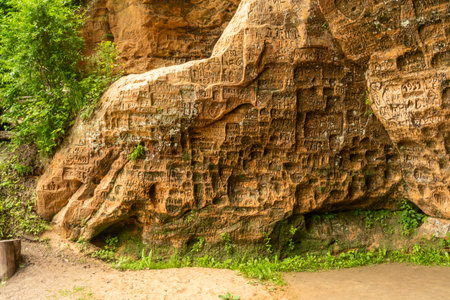 Sigulda, Latvia - June, 22 2025: Gutman's Cave with inscriptions on the walls, the widest and highest cave in the Baltic countries, in the Gauja National Park near Sigulda, Latviaの写真素材