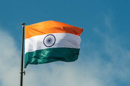 Beautiful Indian national flag waving in the wind against a clear blue sky. The tricolor flag...