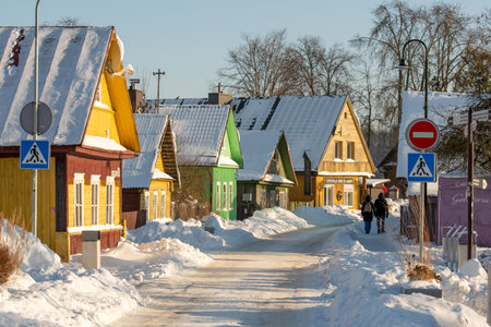 Trakai, Lithuania - January 18 2026: Old Lithuanian beautiful traditional wooden houses in the old town of Trakai, Lithuania, in a winter sunny day covered by snowのeditorial素材