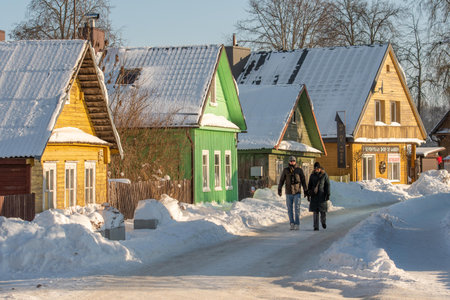 Trakai, Lithuania - January 18 2026: Old Lithuanian beautiful traditional wooden houses in the old town of Trakai, Lithuania, in a winter sunny day covered by snowのeditorial素材