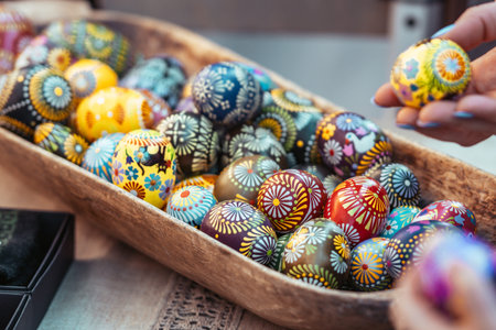 Traditional Lithuanian wooden colorful Easter eggs in a wooden basket, symbol of fertility and life...