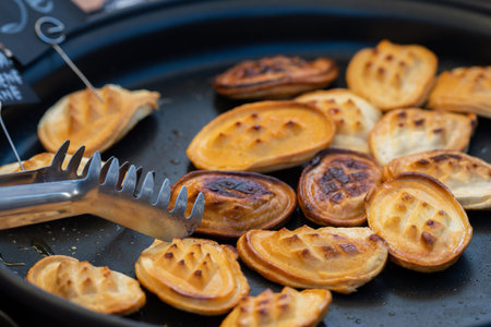 Grilling traditional oscypek cheese on a pan, a smoked cheese made of salted sheep milk exclusively...